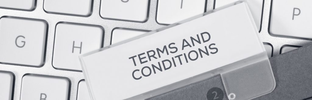 terms and conditions document in front of a keyboard closeup