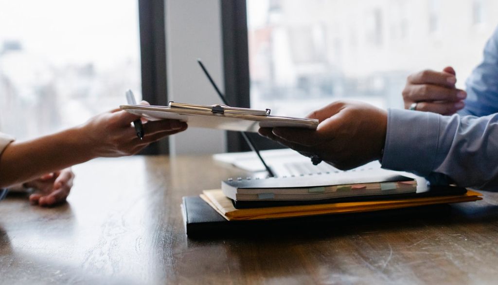 assistant showing report to the executives