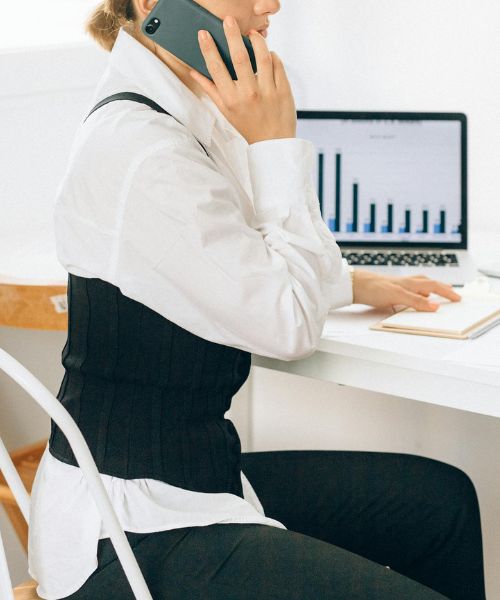 executive assistant is writing down in front of senior manager